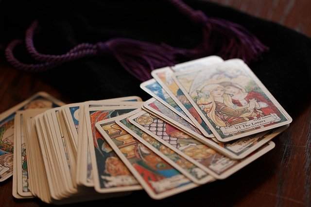 Old fashioned tarot cards spread out on a black surface